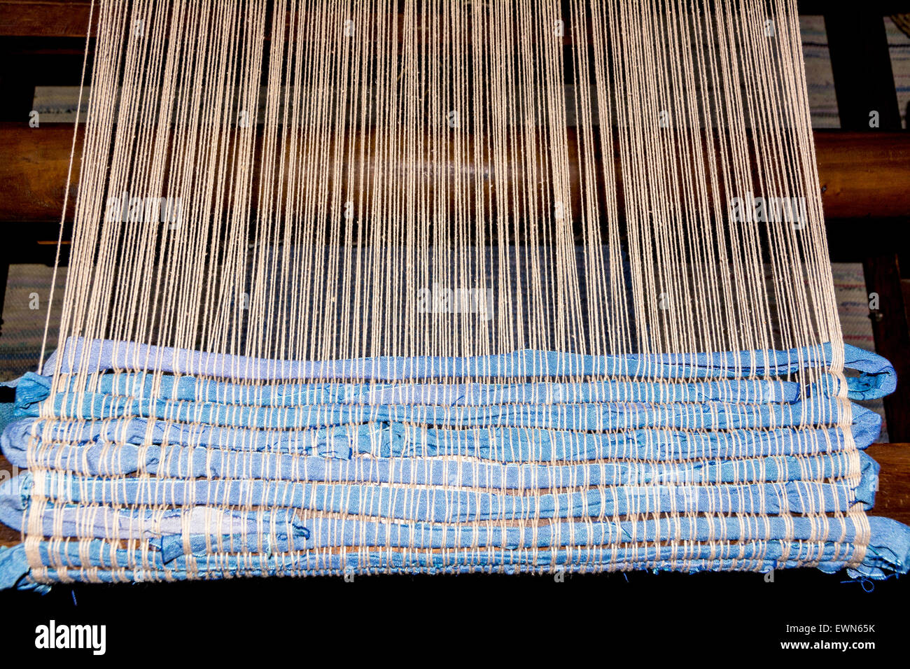 Weaving on a loom with fabric Stock Photo Alamy