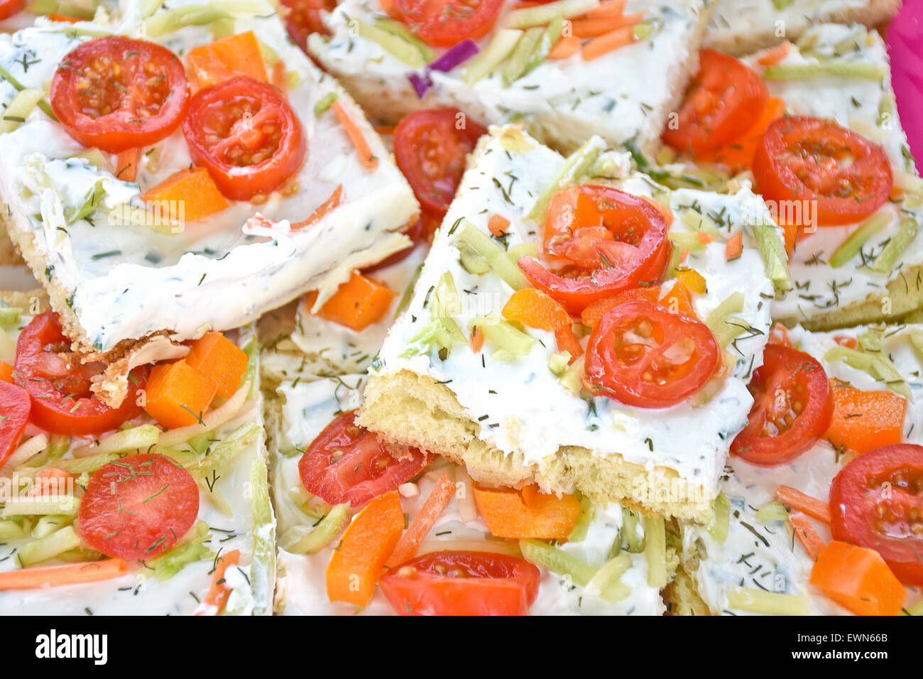 Sliced tomatoes on cream cheese for party appetizer. Stock Photo