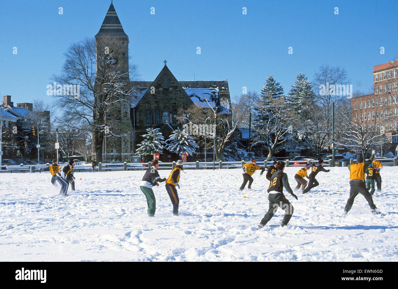 CAMBRIDGE MASS. USA. HARVARD STUDENTS PLAY FOOTBALL IN A SNOW COVERED FIELD. Stock Photo