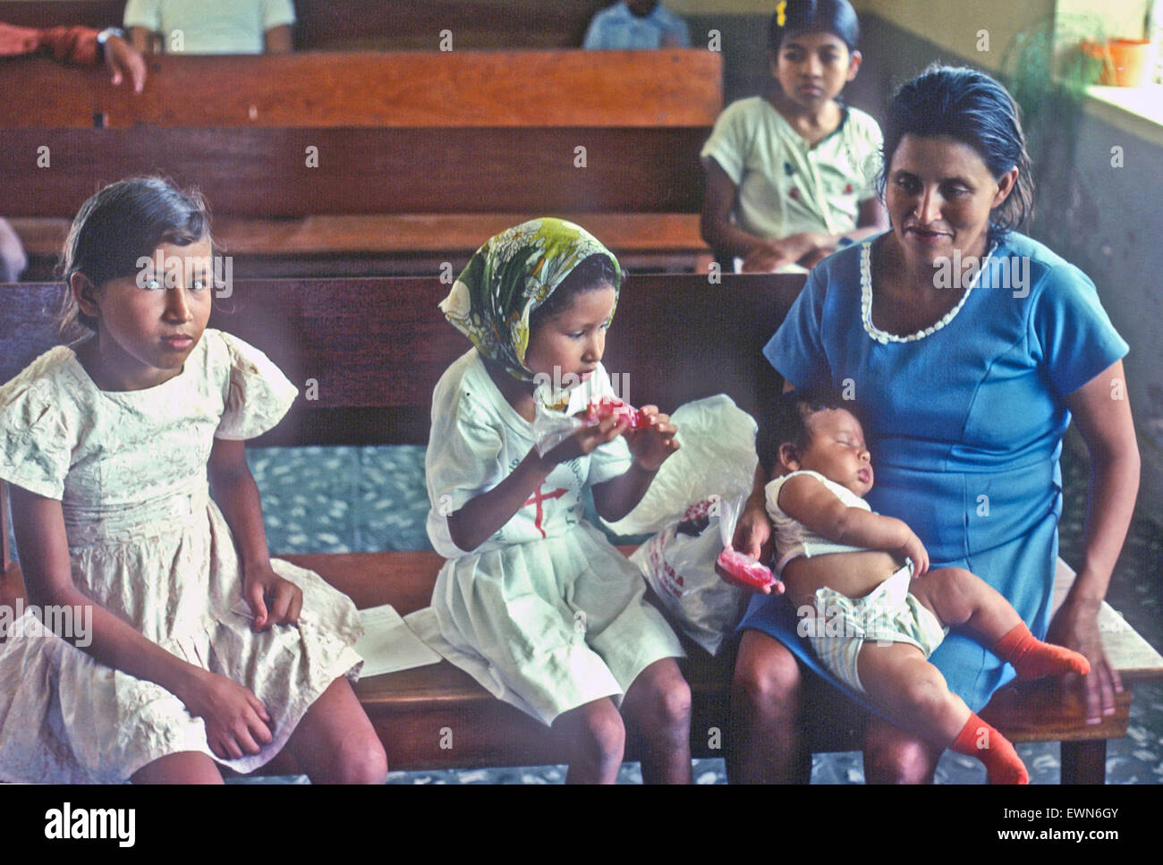 GUATEMALA-   A MOTHER AND HER CHILDREN AWAIT THEIR TURN AT A MOTHER AND BABY CLINIC, Stock Photo