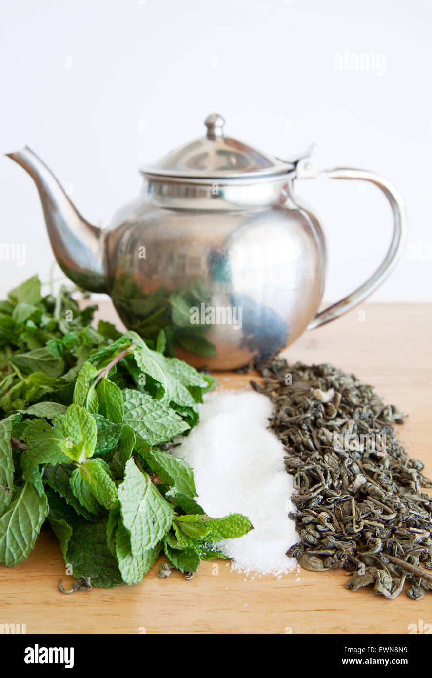 teapot ,sugar,green tea and peppermint to make morrocan tea Stock Photo