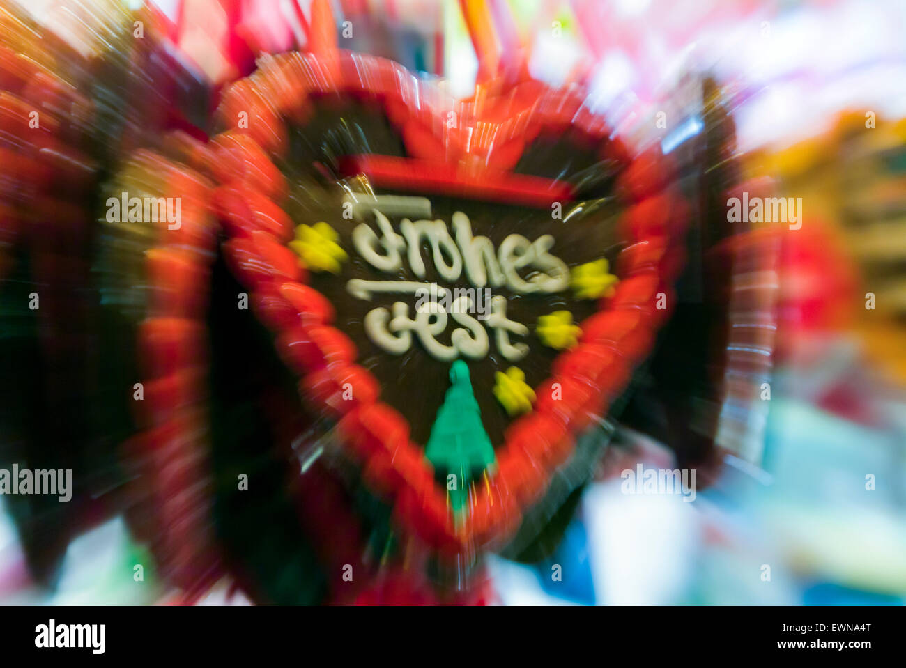 'Frohes Fest' means Merry Christmas on a gingerbread heart on a christmas market, zoomed and blurred, in Germany Europe Stock Photo