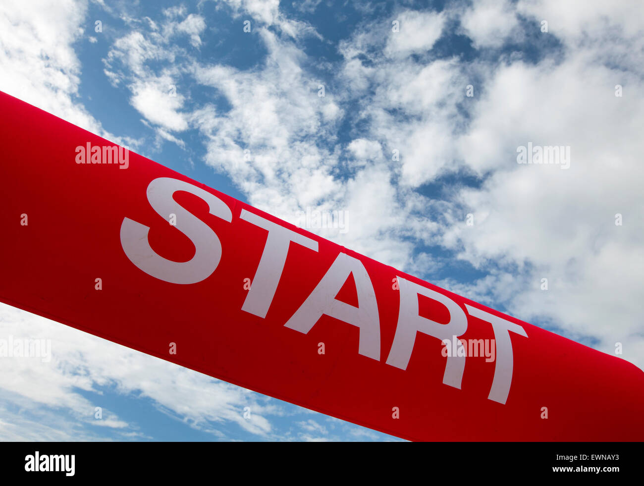 red start line against a blue cloudy sky Stock Photo