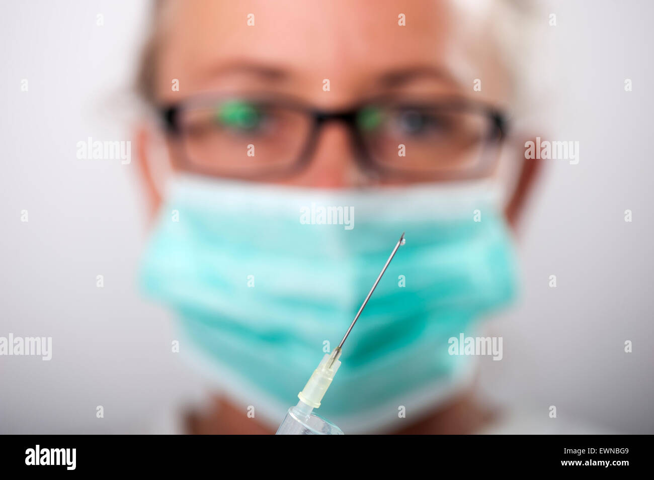 Woman doctor checking injection Stock Photo