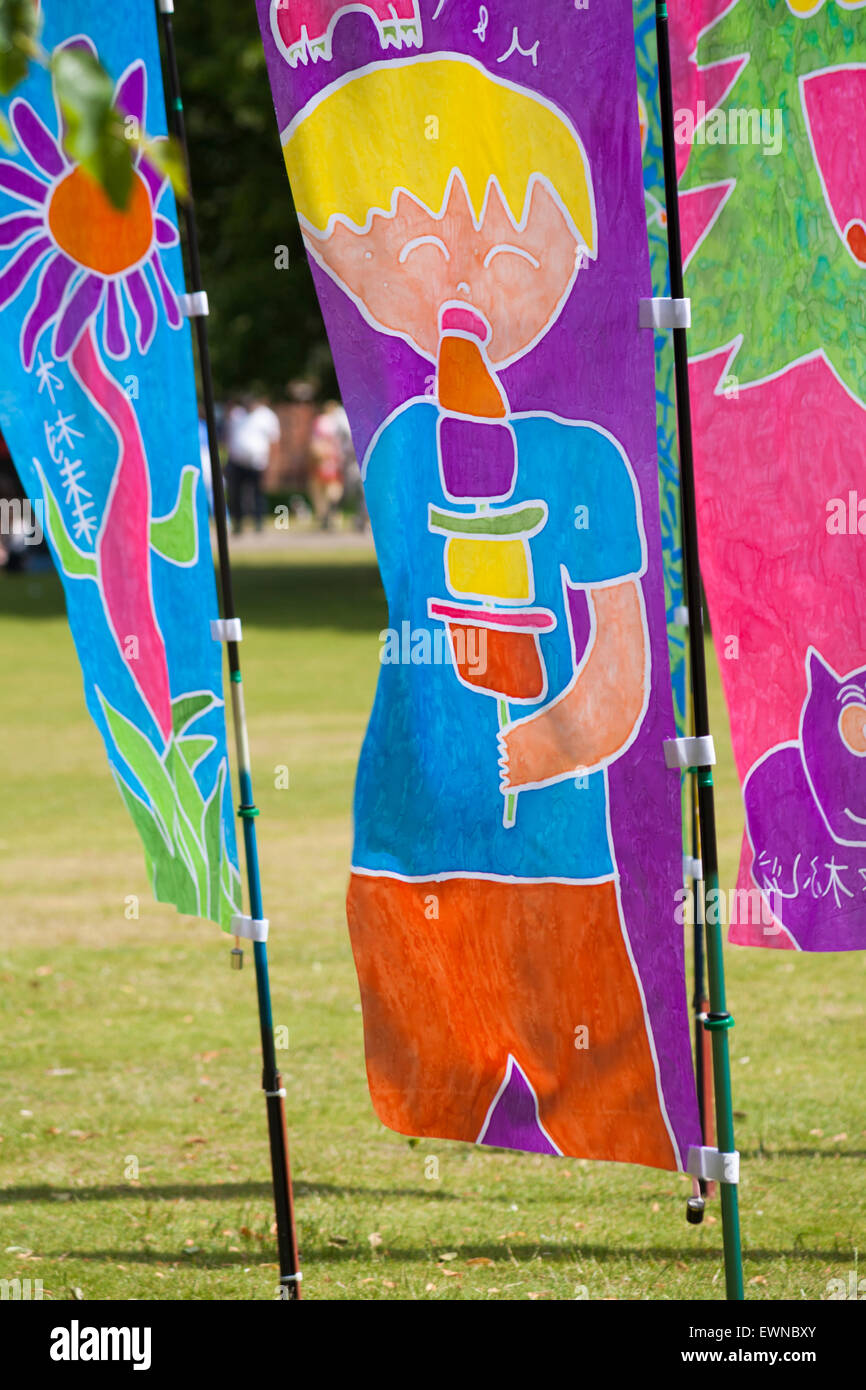 Worlds's Eye Batik Flag installation in the grounds of Salisbury Cathedral, Salisbury, Wilshire, UK in June Stock Photo