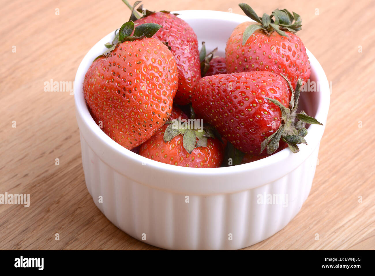 Close up strawberry on wooden plate Stock Photo - Alamy