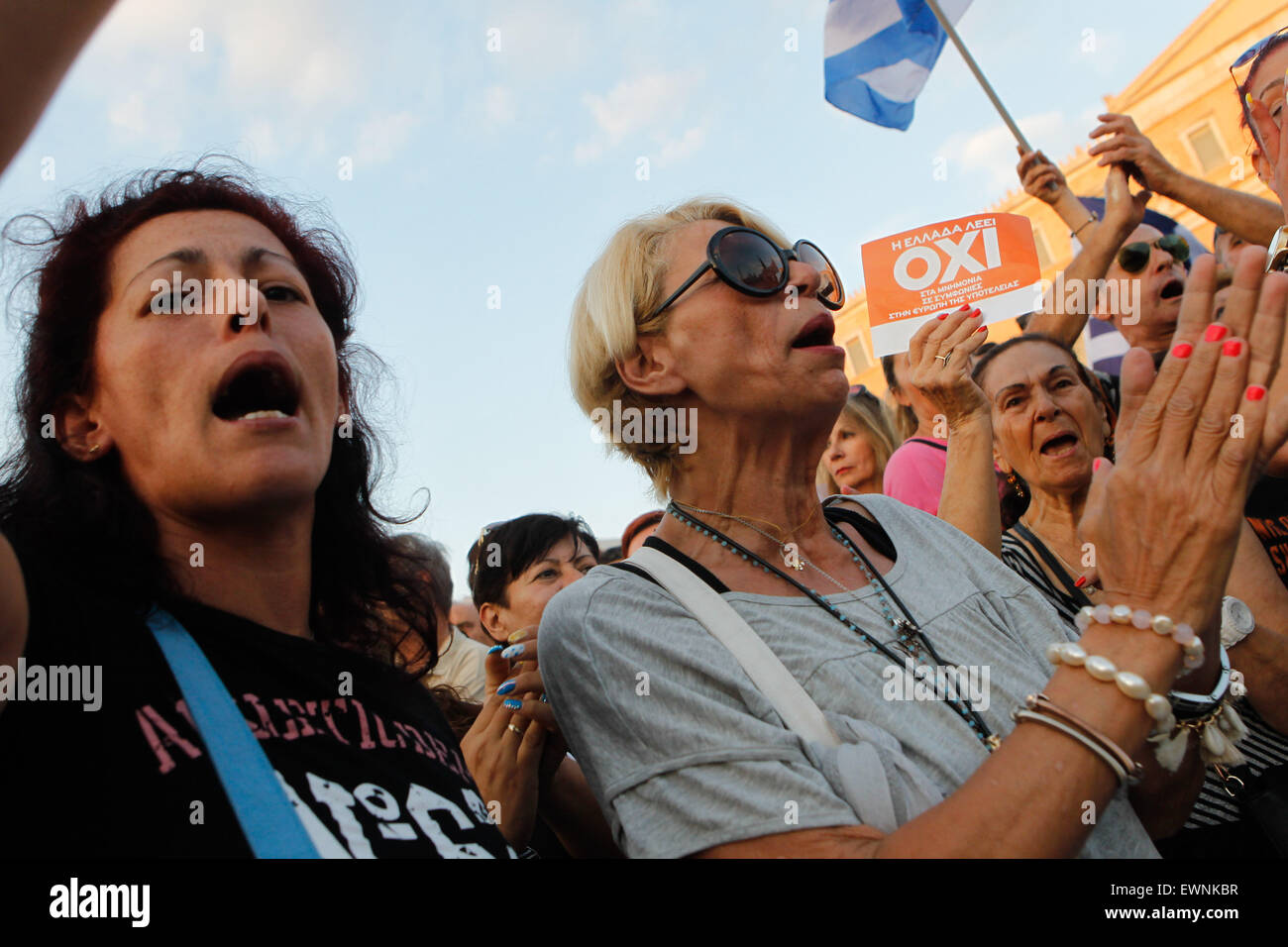 Athens, GREECE. 29th June, 2015. Supporters of the NO vote in the upcoming referendum hold a banner with colors of the Greek flag reading ''NO, OXI'' during a rally at Syntagma. Anxious Greek pensioners swarmed closed bank branches and long lines snaked outside ATMs as Greeks endured the first day of serious controls on their daily economic lives ahead of a July 5 referendum that could determine whether the country has to ditch the euro currency and return to the drachma. © Aristidis Vafeiadakis/ZUMA Wire/Alamy Live News Stock Photo