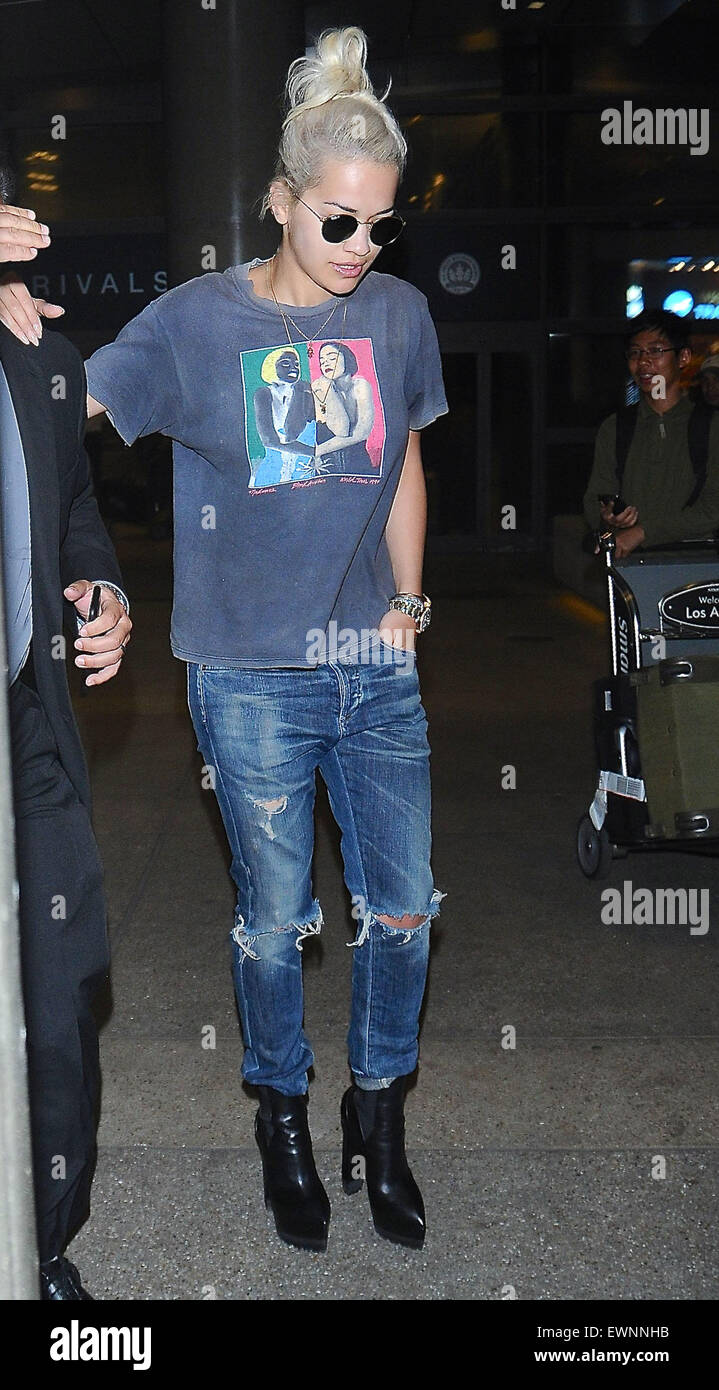 Rita Ora arrives at Los Angeles International Airport (LAX) in platform boots, ripped jeans and a vintage Madonna Blond Ambition World Tour t-shirt from 1990  Featuring: Rita Ora Where: Los Angeles, California, United States When: 23 Apr 2015 Stock Photo