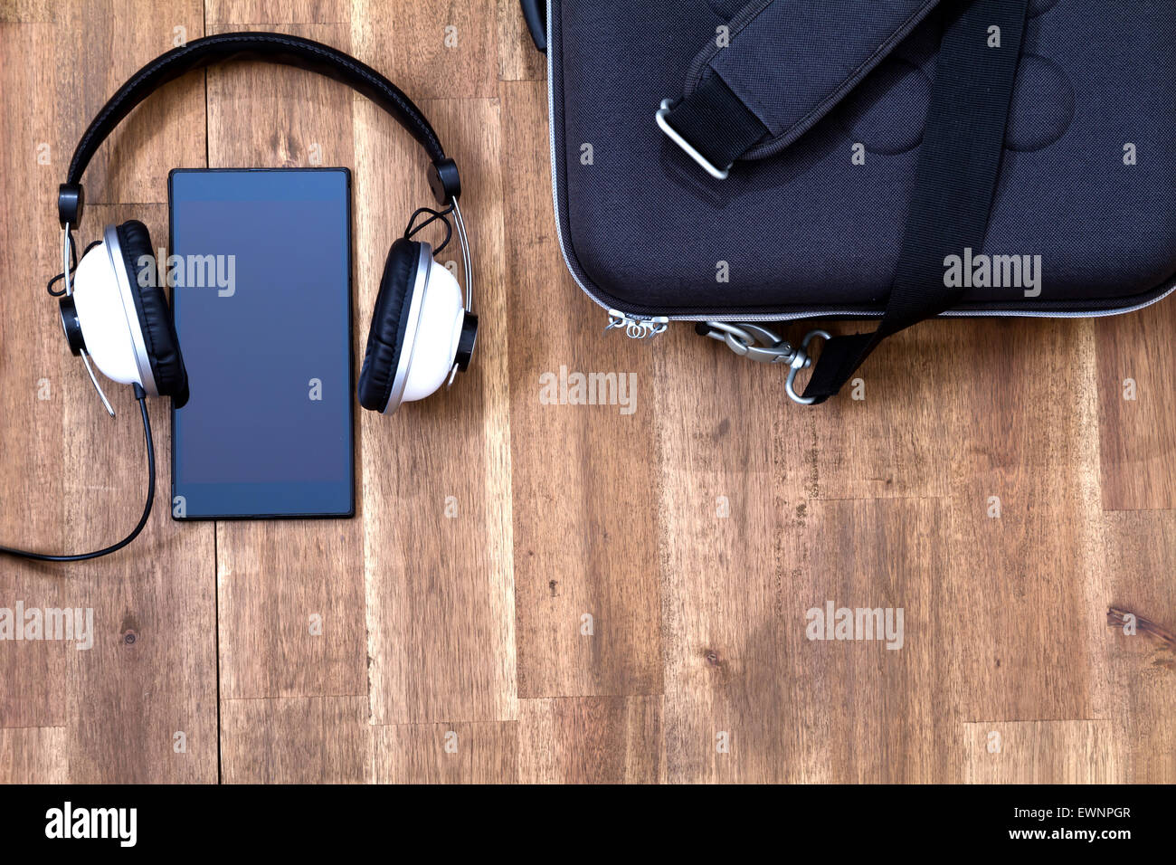 Cellphone with headphone and a briefcase background Stock Photo