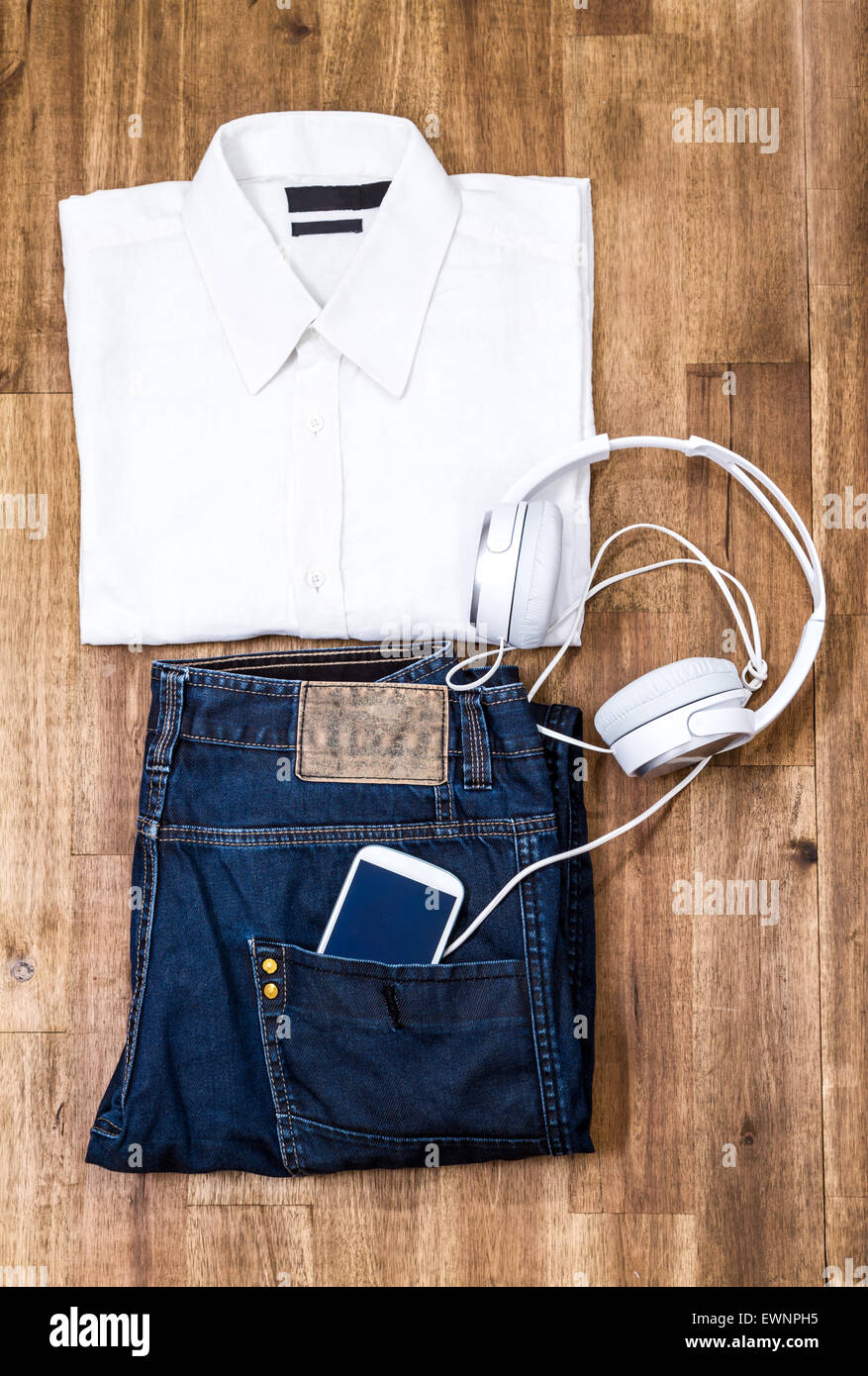 Informal male outfit with cellphone and headphone, background Stock Photo