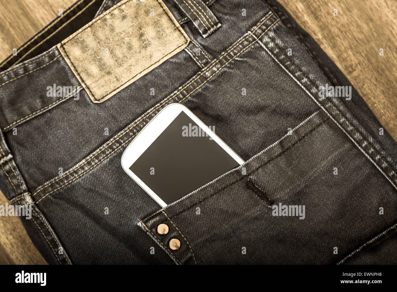 Jeans with cellphone in the pocket, background Stock Photo