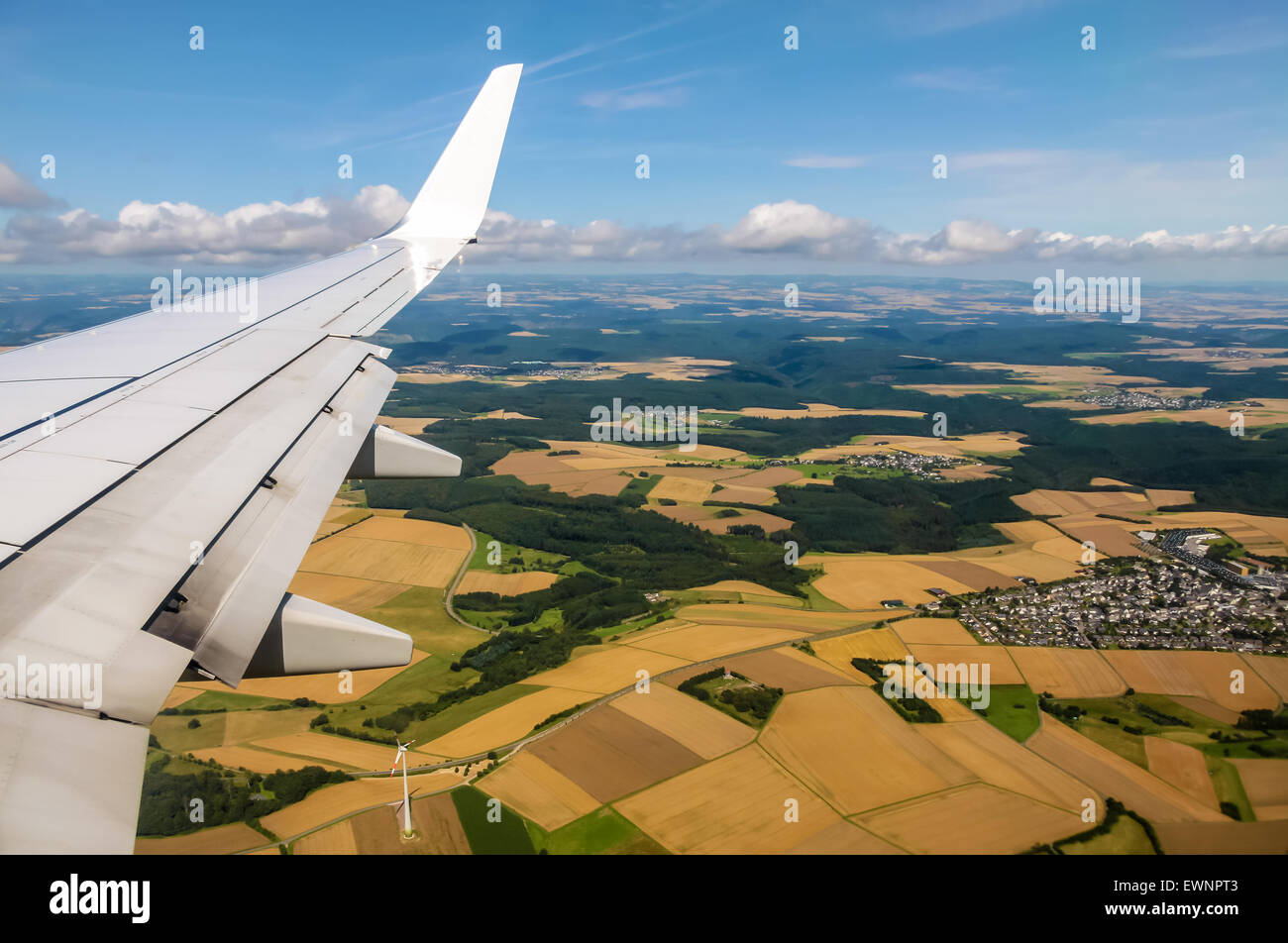 Aerial view of plane wing and fields above the Hunsrueck, Germany Stock Photo