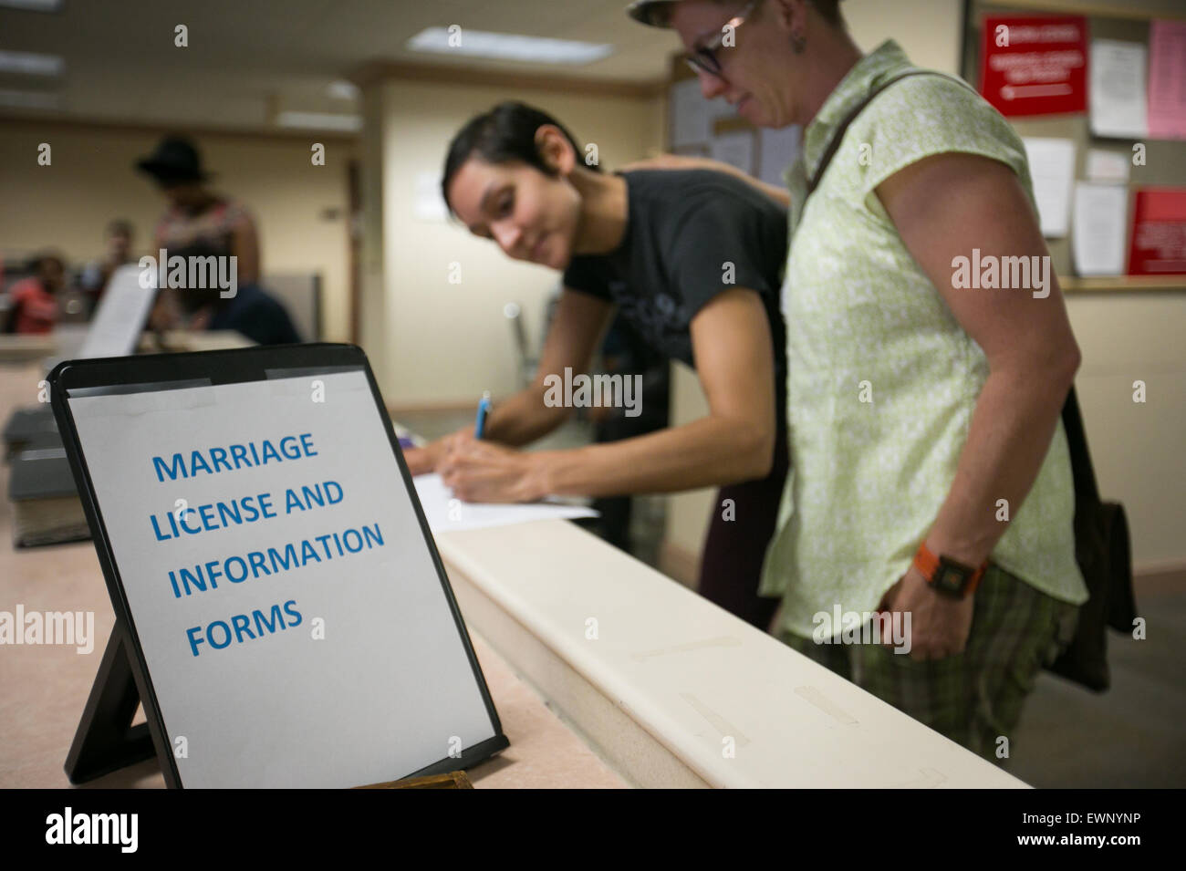 Catherine Simonsen (hat and shorts) and Laura Rivera apply for a marriage license in Georgia on June 26, 2016. Stock Photo