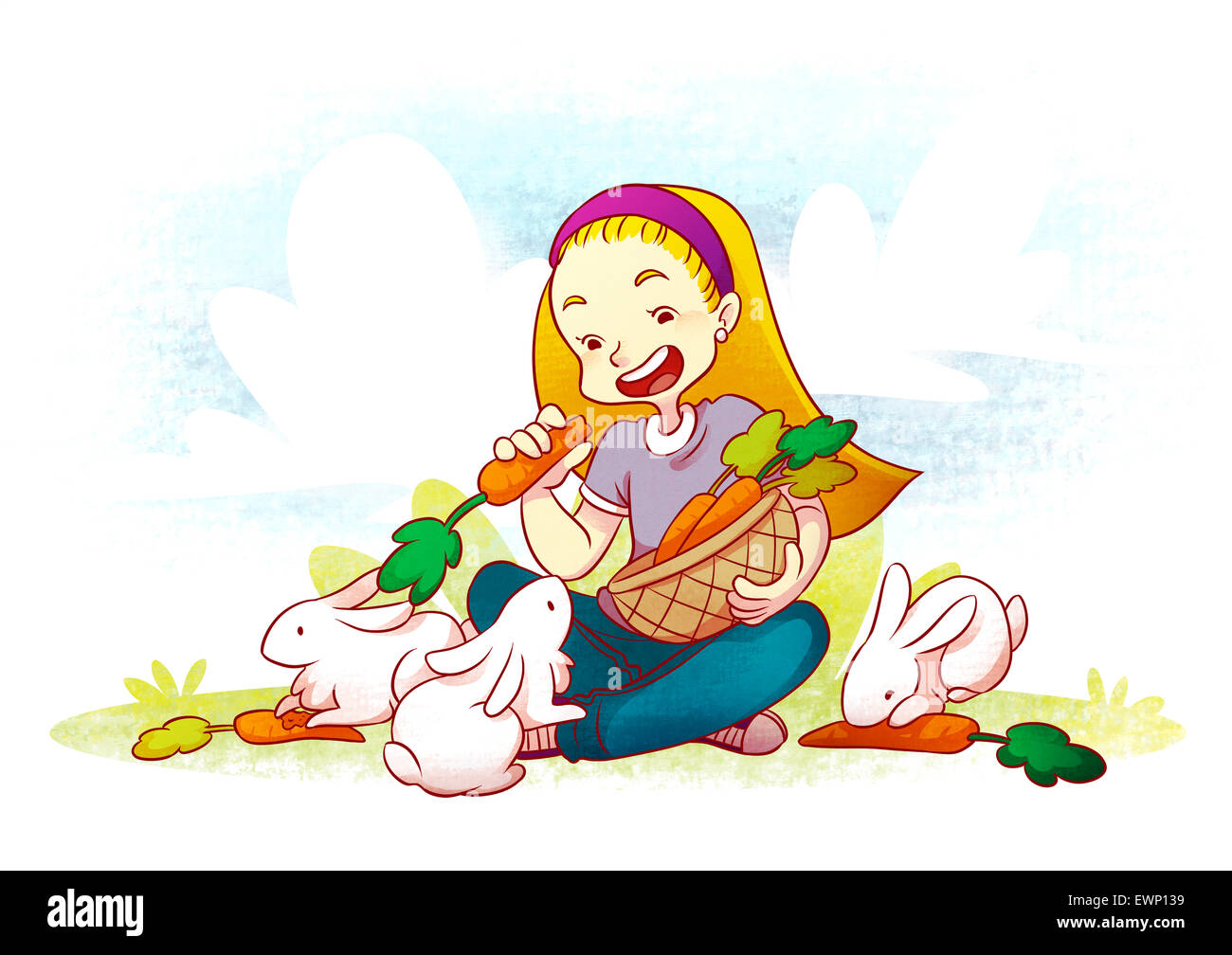 Girl sitting in garden with rabbits holding carrots Stock Photo