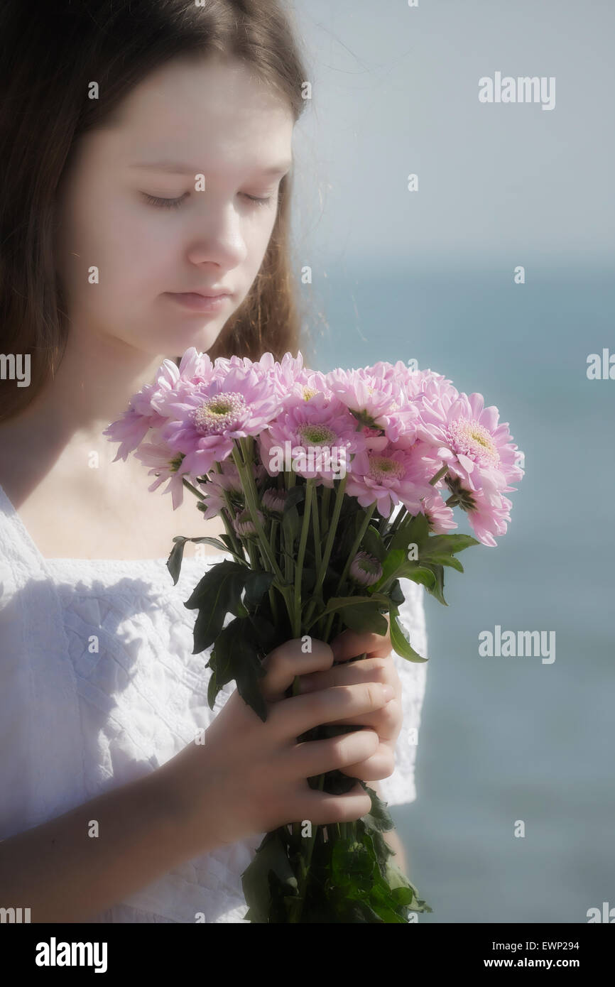 a girl holding a bouquet of flowers Stock Photo