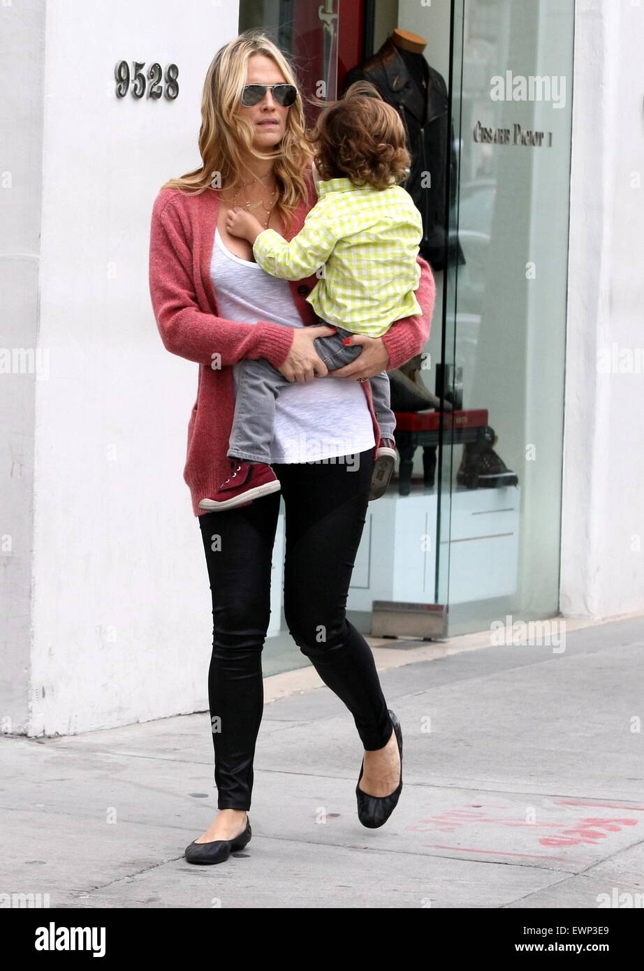 Molly Sims carries her son Brooks in her arms as they go for a car journey  Featuring: Molly Sims,Brooks Stuber Where: Los Angeles, United States When:  12 Mar 2014 Stock Photo - Alamy