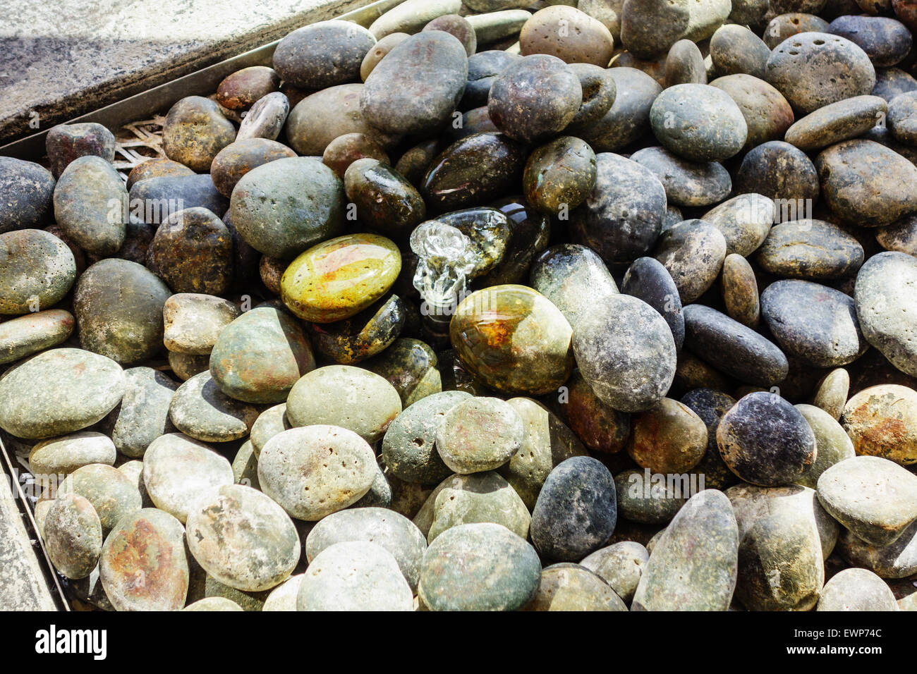 A bubble up water over stones feature in an atrium. Stock Photo