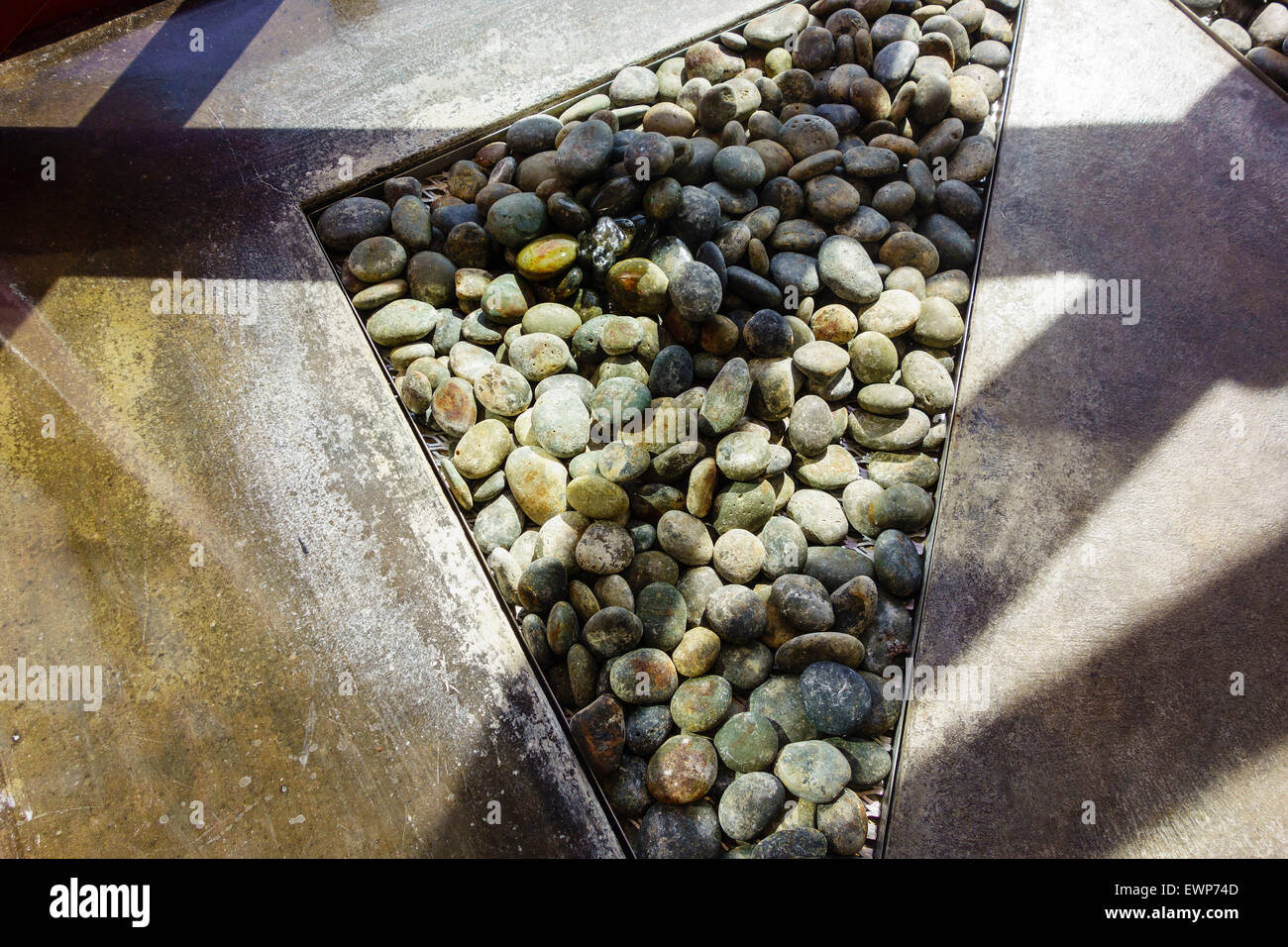 A bubble up water over stones feature in an atrium. Stock Photo