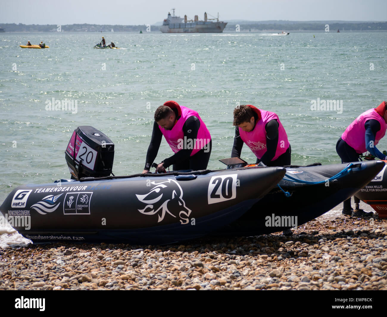 Boat crew make final preparations prior to a thundercat power boat race in the Solent Stock Photo