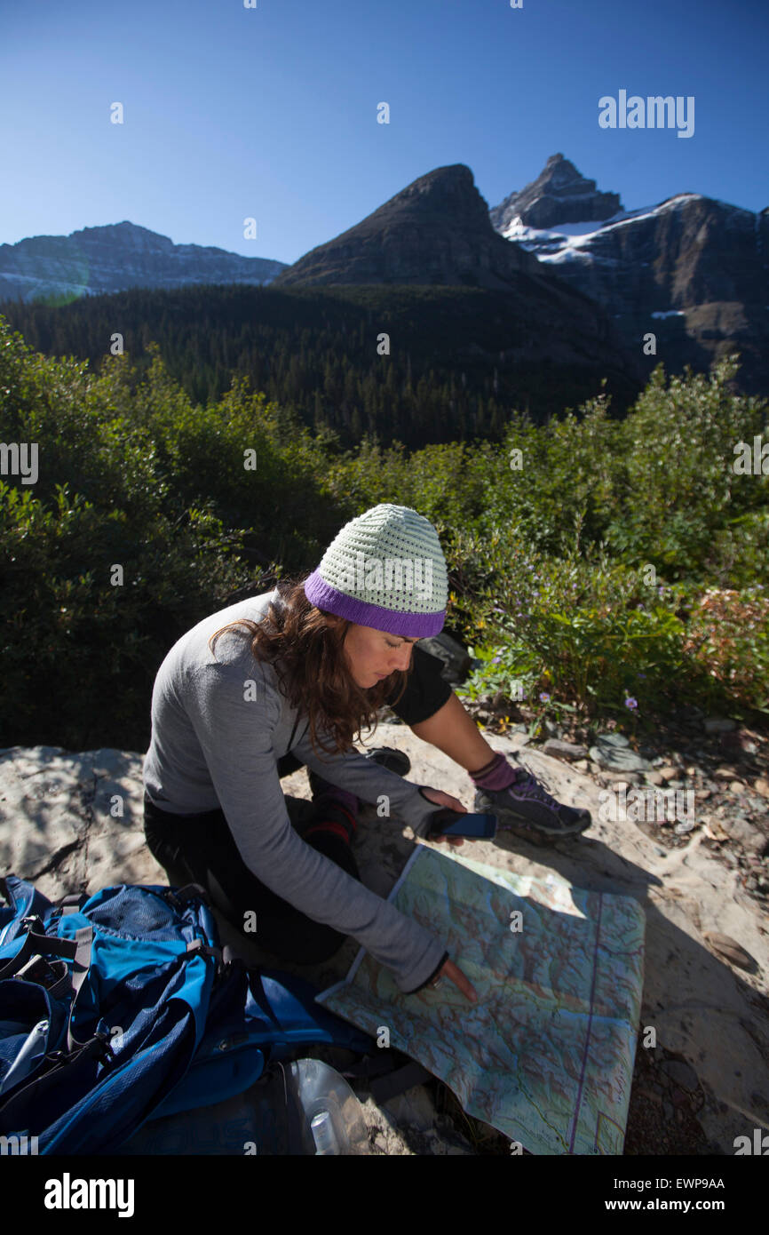 A woman reading a map in the high country. Stock Photo