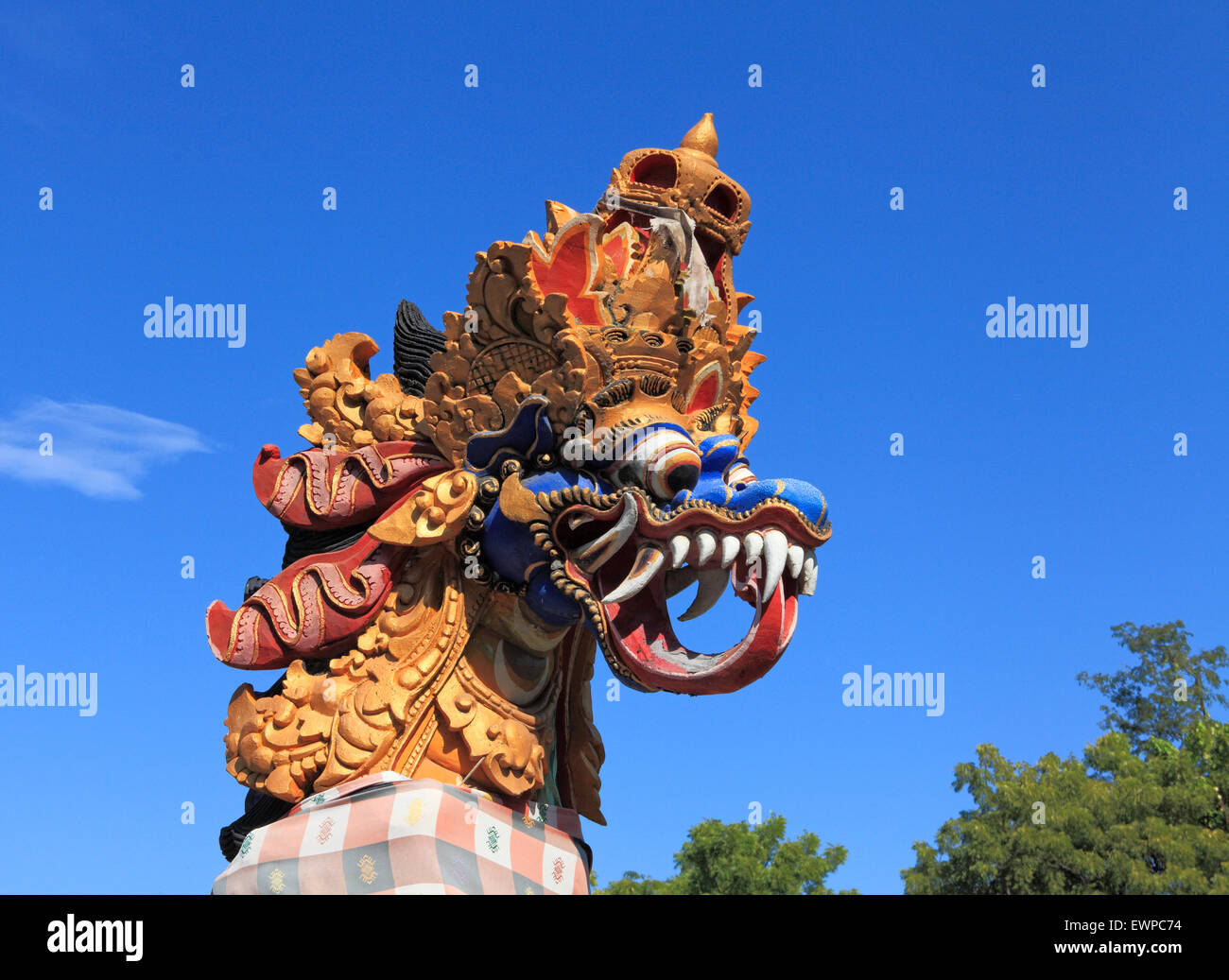 Brightly painted stone dragon statue outside Pura Dalem Dencarik Temple