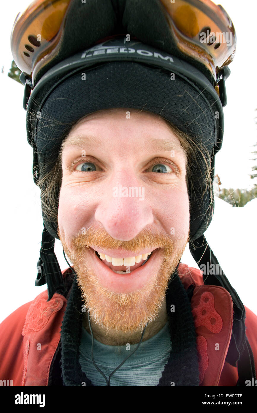 Man poses for a goofy portrait after skiing. Stock Photo