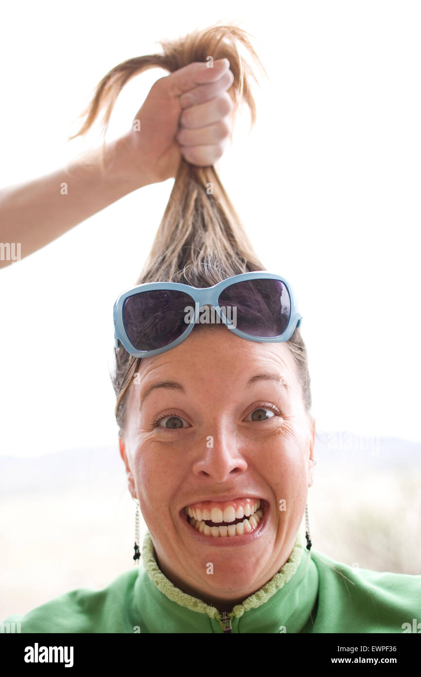 Woman having her hair pulled Stock Photo