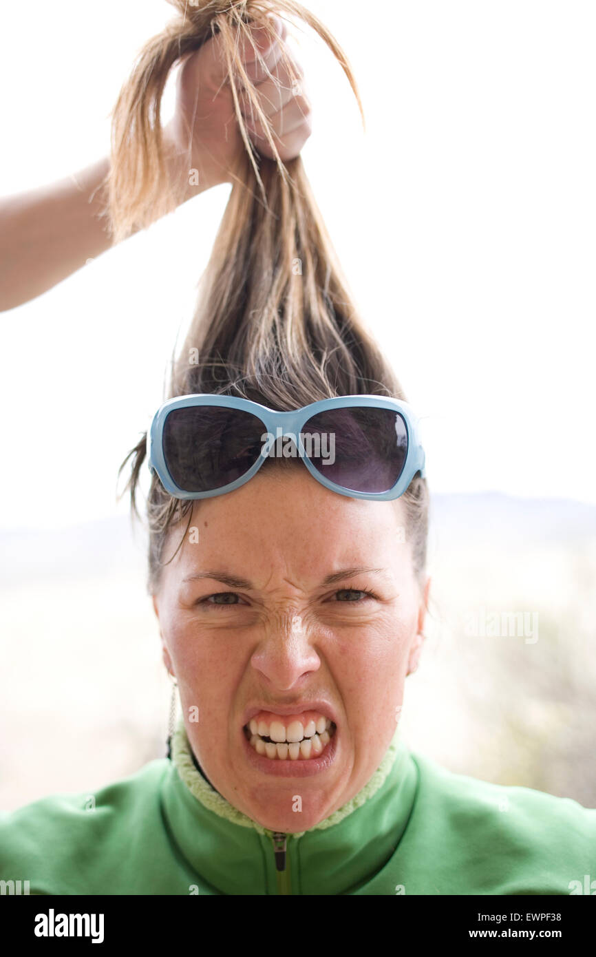 Woman having her hair pulled Stock Photo