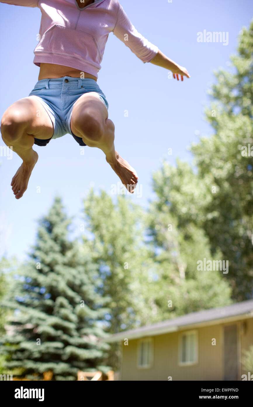 Adult woman jumping in the air. Stock Photo