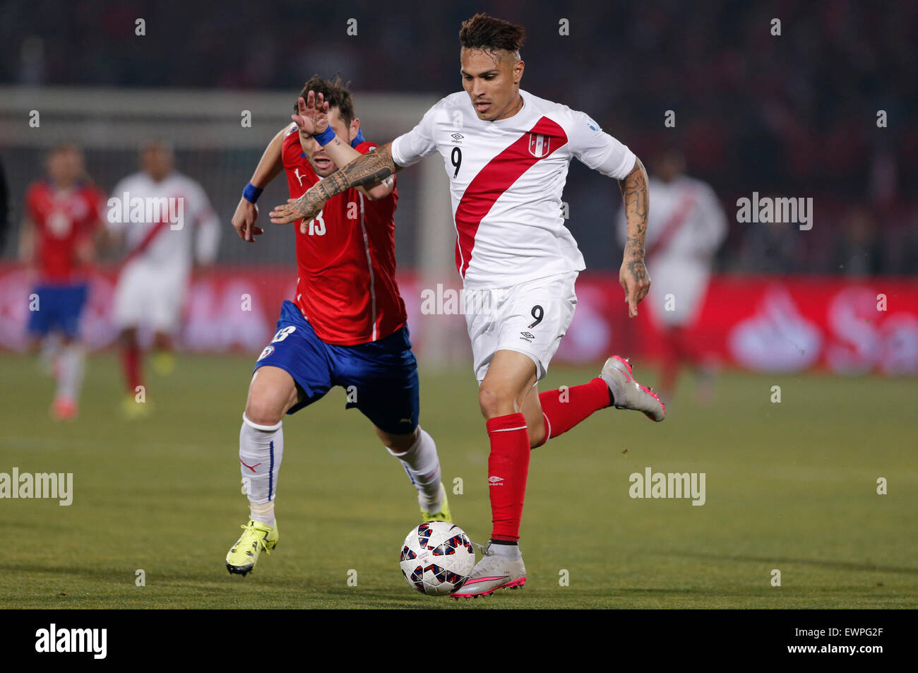 Santiago, Chile. 29th June, 2015. Jose Rojas (L) from Chile vies for the ball with Paolo Guerrero (R) from Peru during the Copa America Chile 2015 semifinal match, held at National Stadium, in Santiago, Chile, on June 29, 2015. Chile won 2-1 Credit:  Guillermo Arias/Xinhua/Alamy Live News Stock Photo