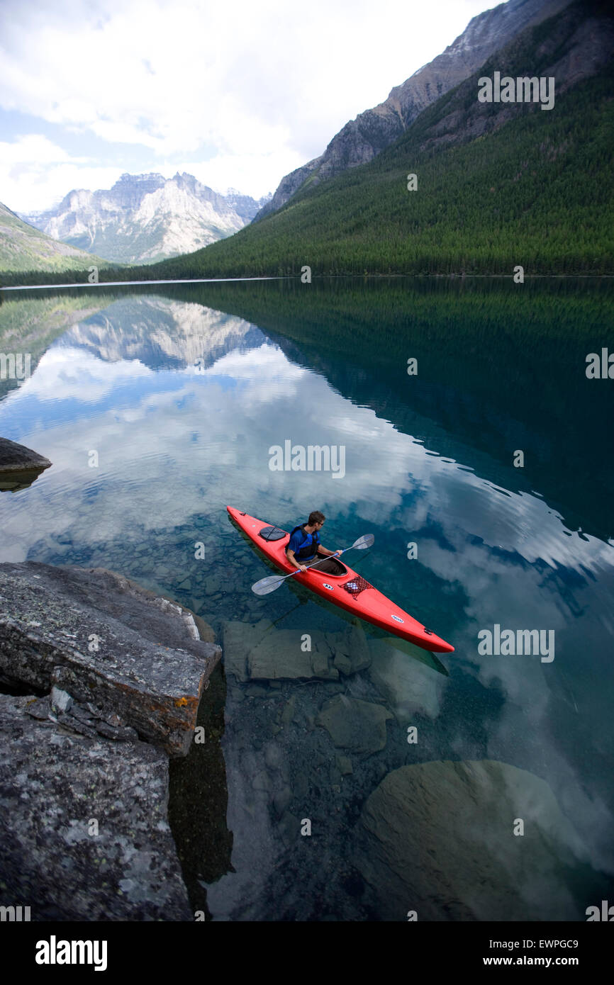 Man kayaks alone on a mountain lake Stock Photo Alamy