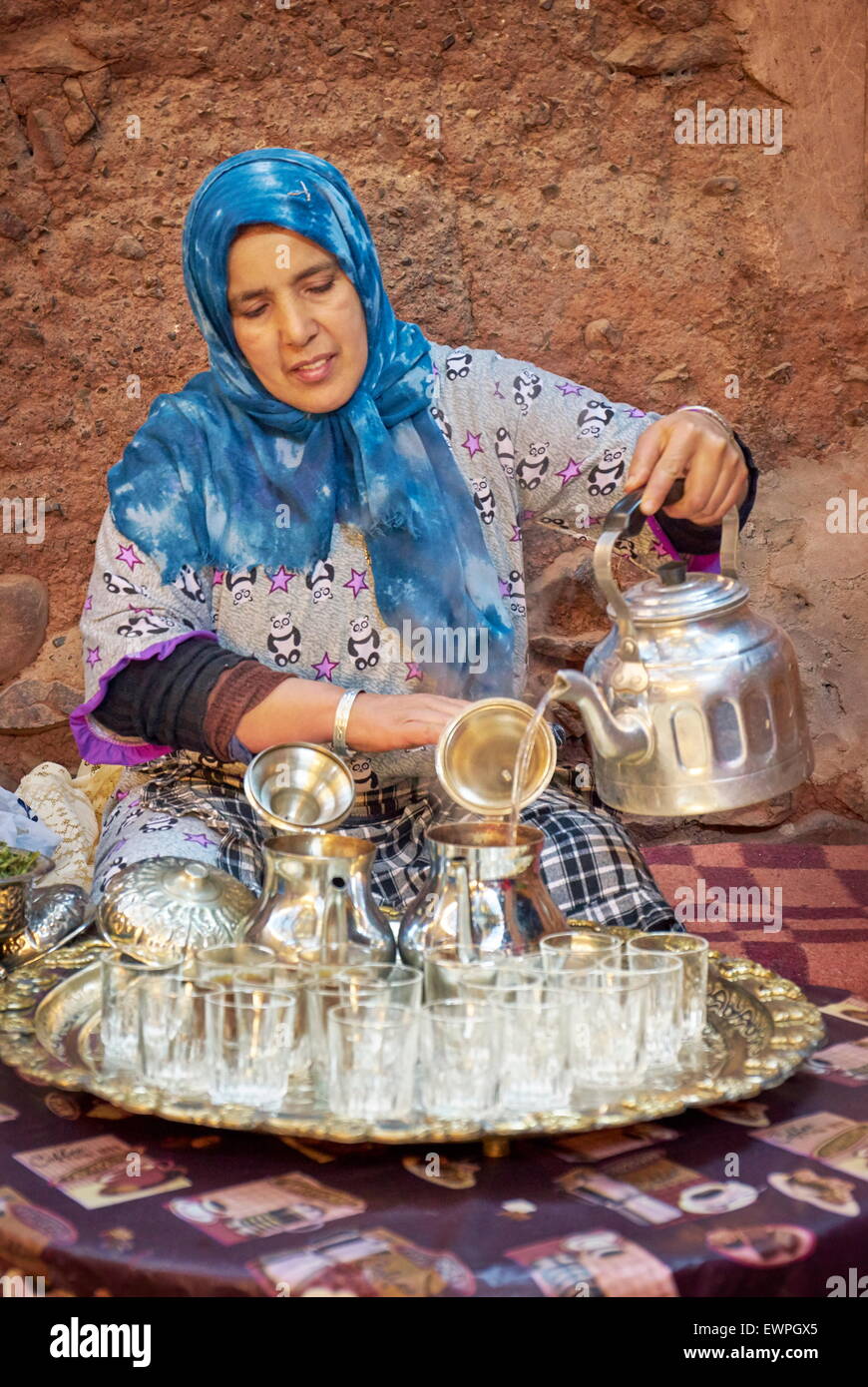 Traditional tea ceremony. Berber women preparing tea with mint and verbena. Ourica Valley, Morocco Stock Photo