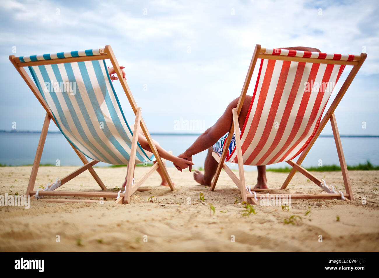 Restful couple sunbathing on the beach Stock Photo