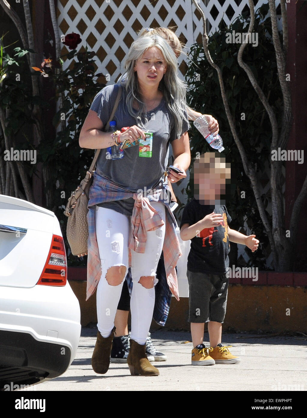 Hilary Duff still sporting her dyed hair, takes her son Luca to The Co-op in Studio City as he was cooled down on a hot spring day, getting sprinkled with bottled water by his nanny  Featuring: Hilary Duff, Luca Comrie Where: Los Angeles, California, United States When: 28 Apr 2015 C Stock Photo