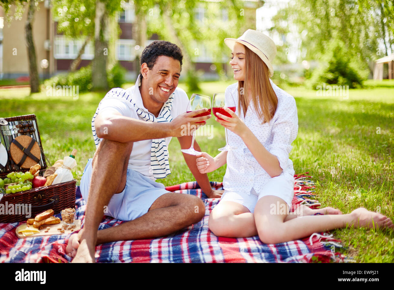 Happy young couple having picnic in park Stock Photo Alamy