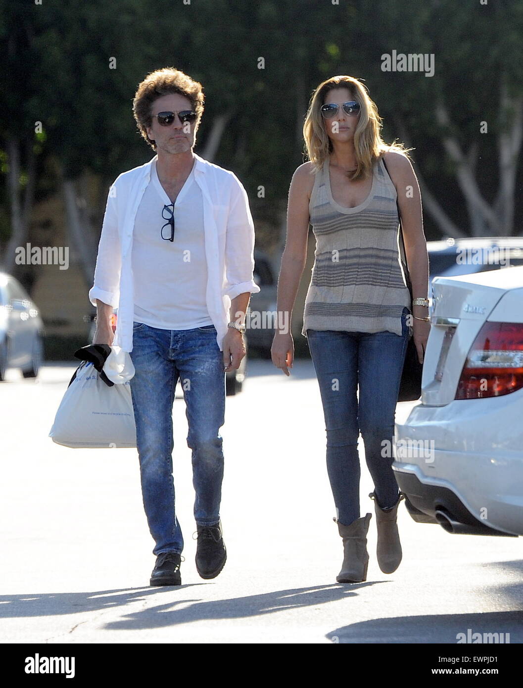 Model Daisy Fuentes flaunts her famous curves at the age of 48 while out shopping with her new boyfriend singer Richard Marx. The new couple were seen holding hands while shopping at Urban Outfitters in Studio City. Daisy also seen checking out her new yellow diamond ring on her wedding ring finger. Richard who recently split from his wife of 25 years last year has been linked to daisy since then.  Featuring: Daisy Fuentes, Richard Marx Where: Studio City, California, United States When: 28 Apr 2015 C Stock Photo