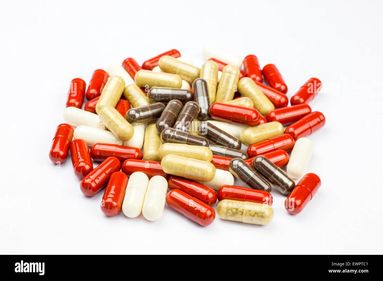 Pile of red brown and white medical capsules against disease for health, isolated on white background Stock Photo