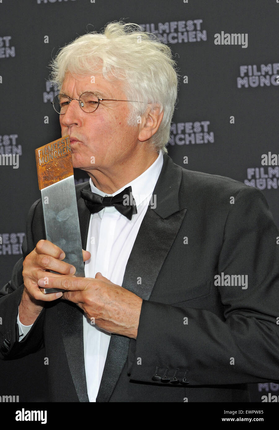 Munich, Germany. 29th June, 2015. French director Jean-Jacques Annaud poses with his CineMerit Award at the film festival in Munich, Germany, 29 June 2015. The Munich International Film Festival has been honouring outstanding figures in the international film industry with the award since 1997. Photo: Ursula Dueren/dpa/Alamy Live News Stock Photo
