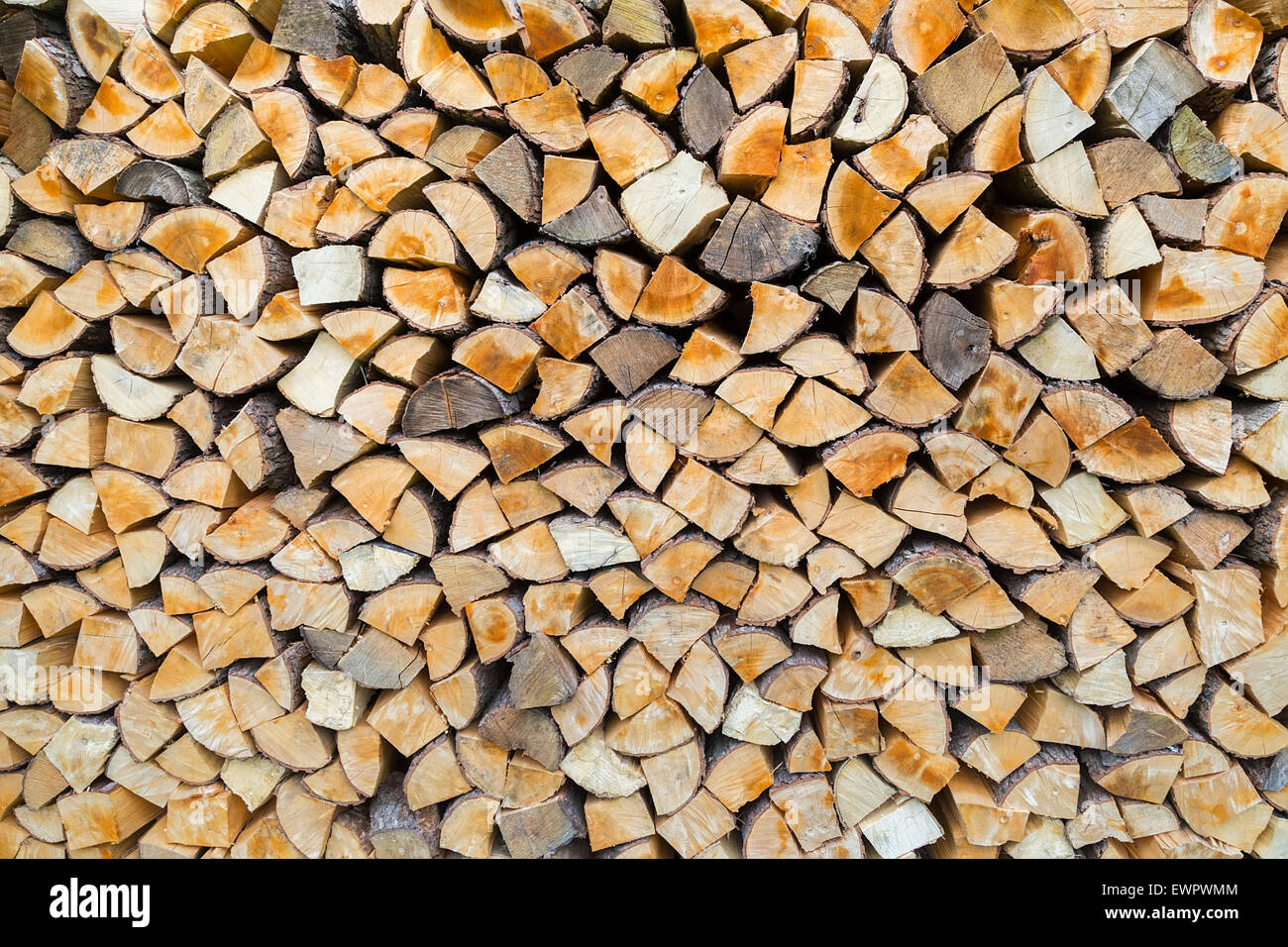 Pile of firewood as tree trunks storage for burning in winter Stock Photo
