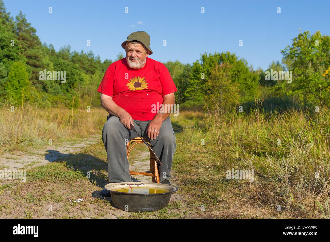 Portrait of an old man with handmade fishing kit Stock Photo