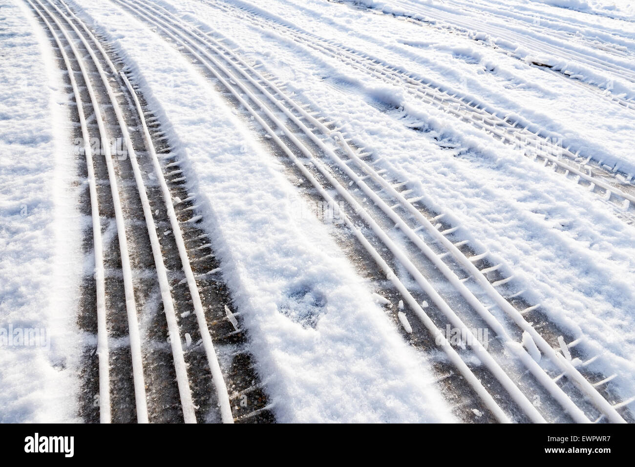 Car tire tracks in snow symbol of transport during winter season Stock Photo