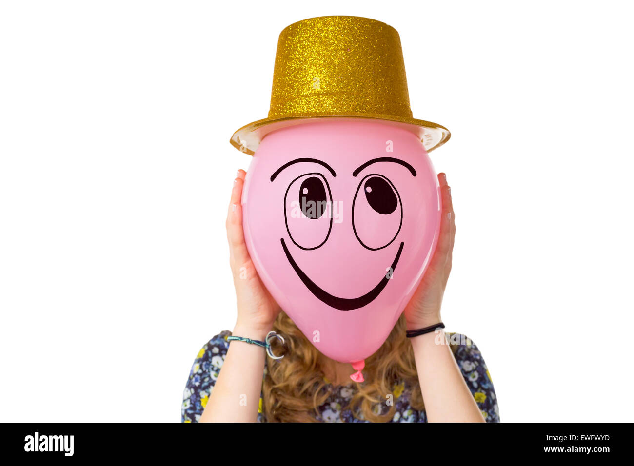 Girl holding balloon with expression of smiling face and gold hat isolated on white background Stock Photo