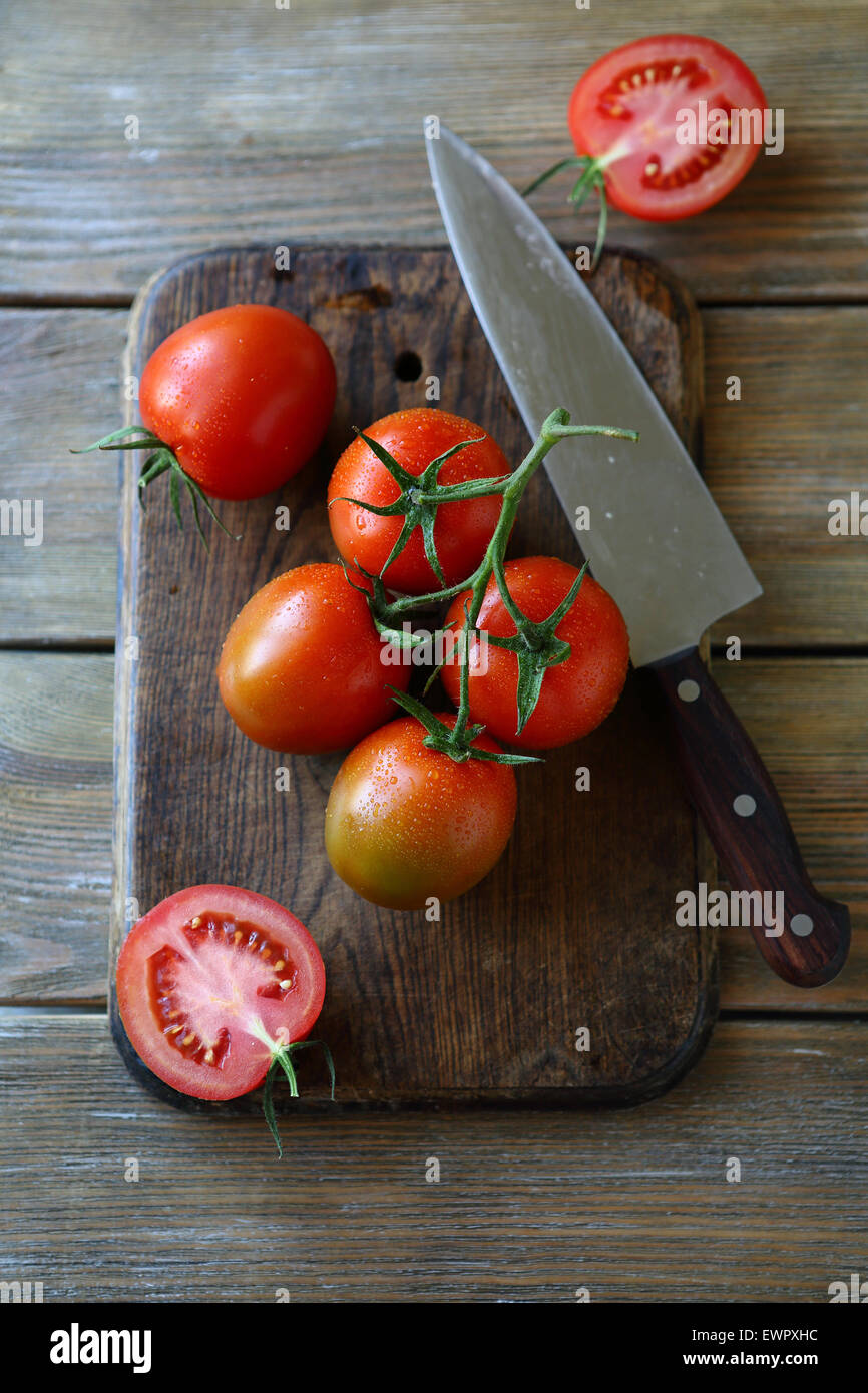 tomatoes on the old cutting board, food top view Stock Photo - Alamy