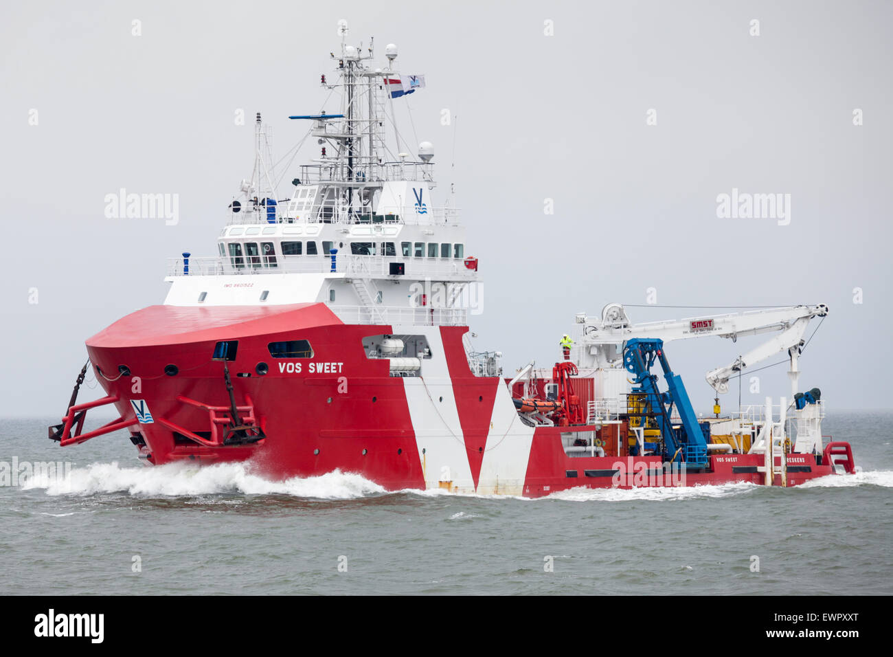 Offshore Support Vessel, Vos Sweet, sailing down the Eems estuary en route to Eemshaven in the Netherlands. Stock Photo