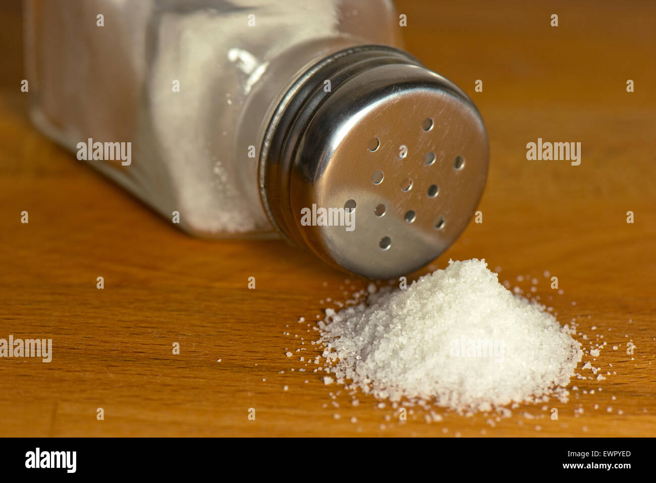 Salt spilling on table from salt cellar Stock Photo Alamy