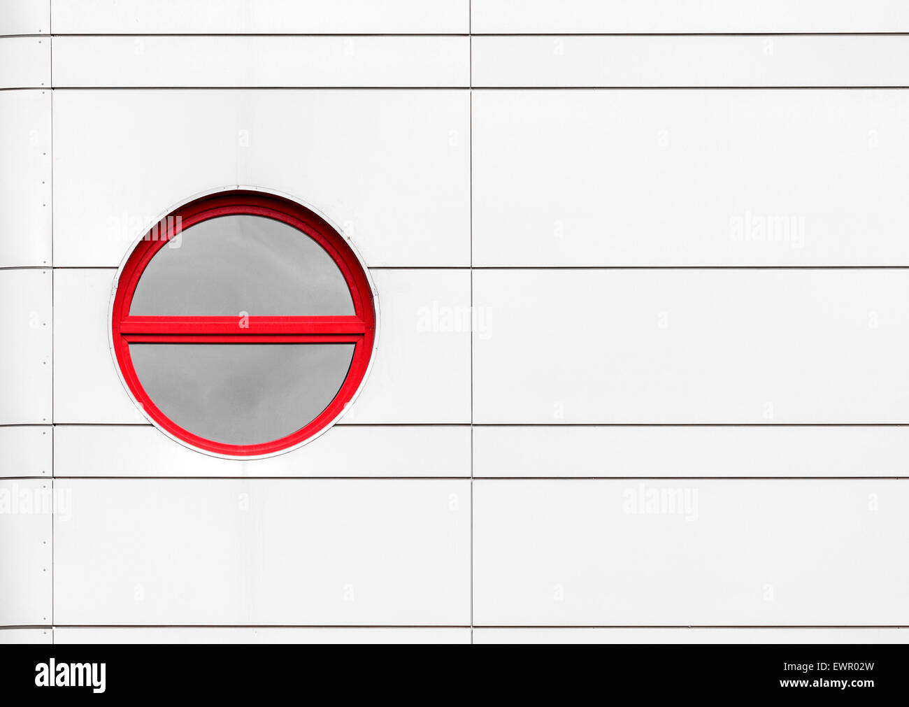 Abstract architecture detail with rounded red window on metal building ...