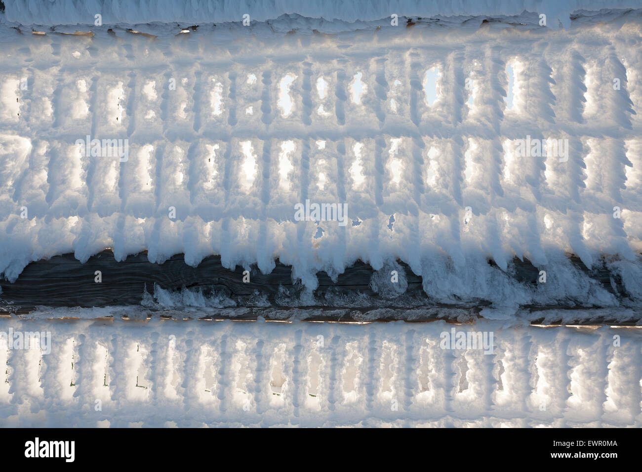 A close up of a fence with snow frozen Stock Photo - Alamy