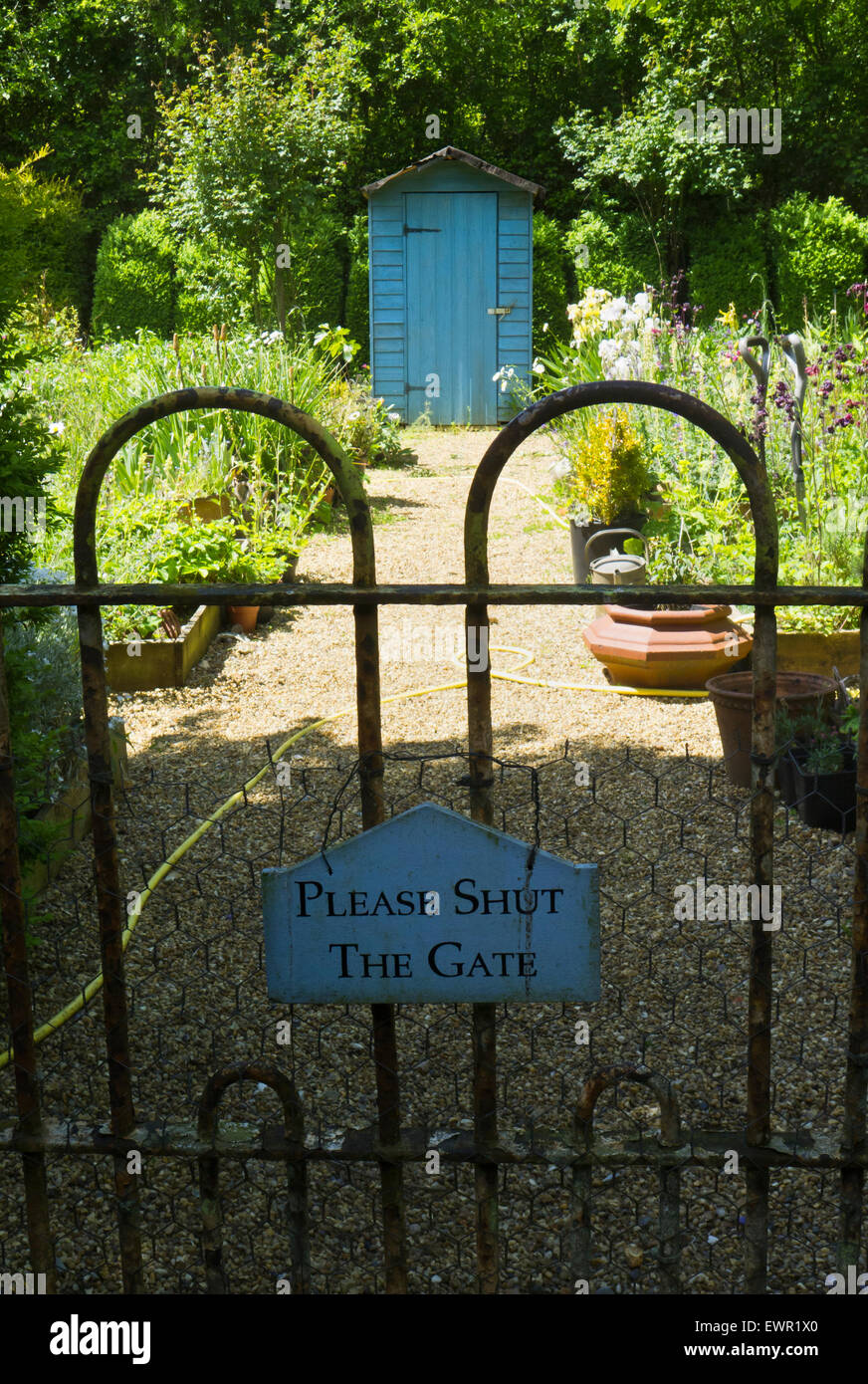 Garden gate with a sign 'PLEASE SHUT THE GATE'. Stock Photo