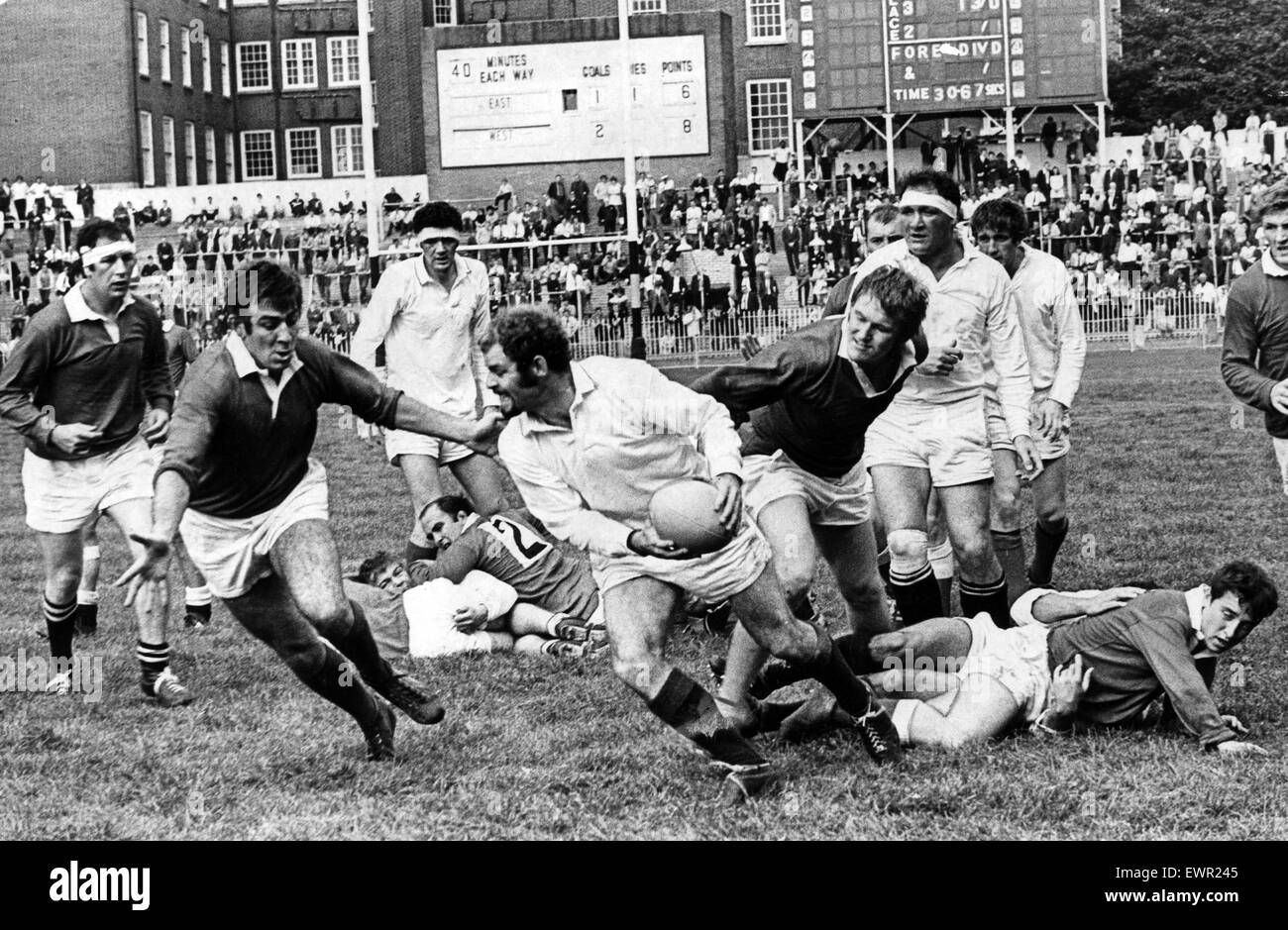 John Taylor, a wing forward for London Welsh, revels in snapping up the loose ball to start attacks, swings a pass out to the East backs before Stuart Gallacher can stop him.  8th September 1969. Stock Photo