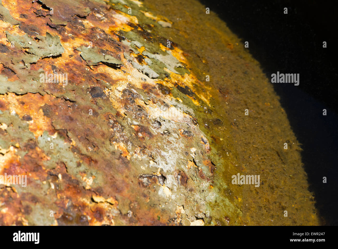 A rusting metal buoy in water. Stock Photo